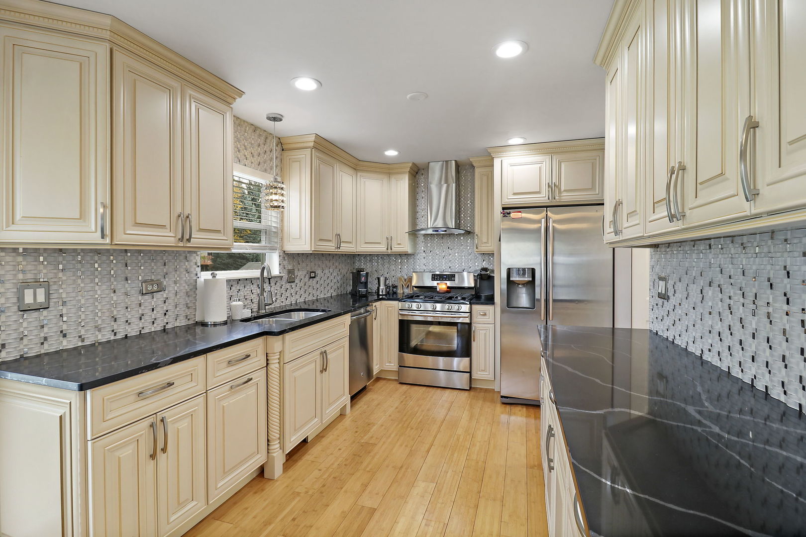 5511 Windgate Way Lake In The Hills, IL 60156 - Photo 7 of 30 a kitchen with granite countertop a refrigerator a sink and white cabinets