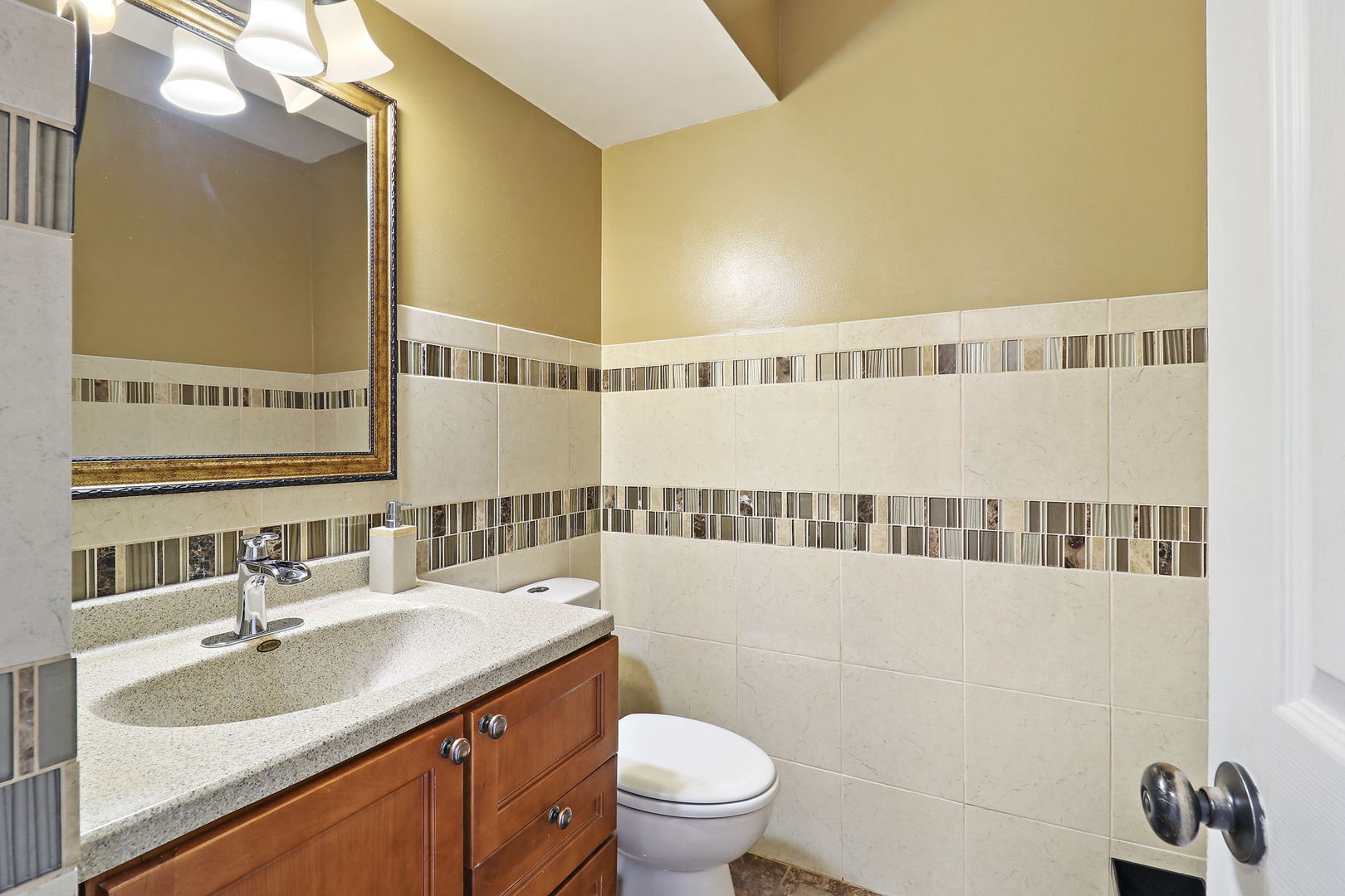 5511 Windgate Way Lake In The Hills, IL 60156 - Photo 10 of 30 a bathroom with a sink a toilet and a mirror