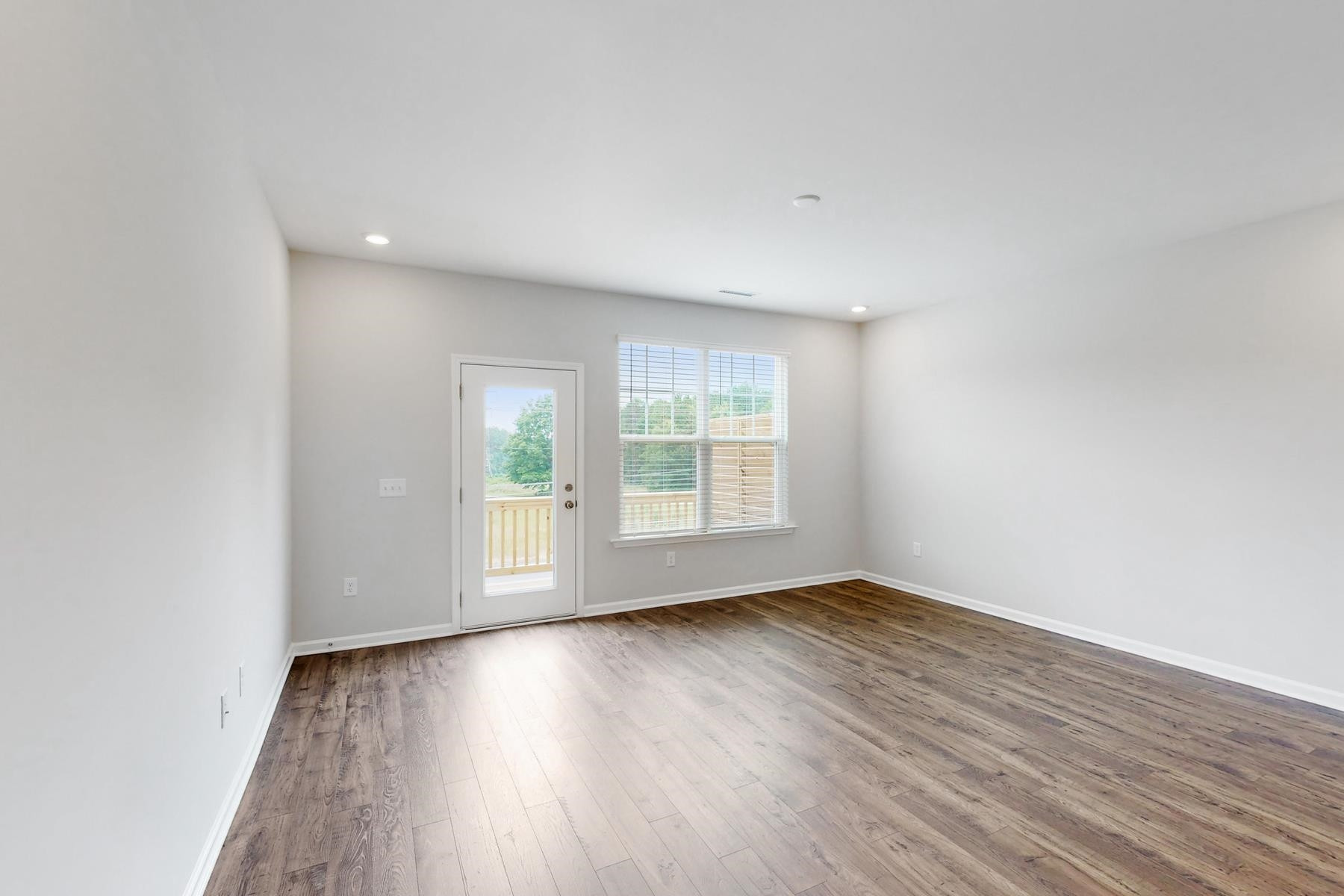 1007 Harmony Trail, Unit 16 Durham, NC 27703 - Photo 14 of 37 an empty room with wooden floor and windows