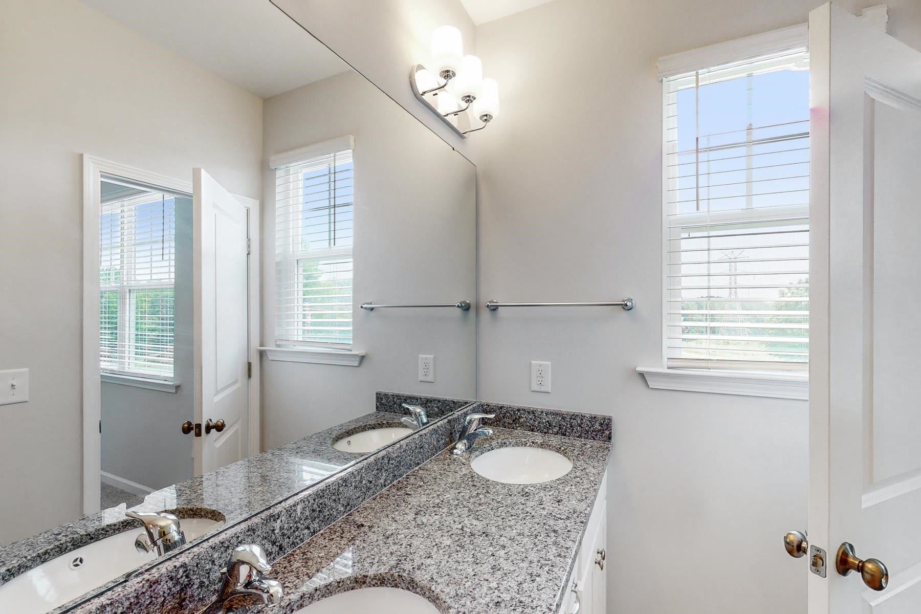 1007 Harmony Trail, Unit 16 Durham, NC 27703 - Photo 18 of 37 a bathroom with a granite countertop sink and a mirror