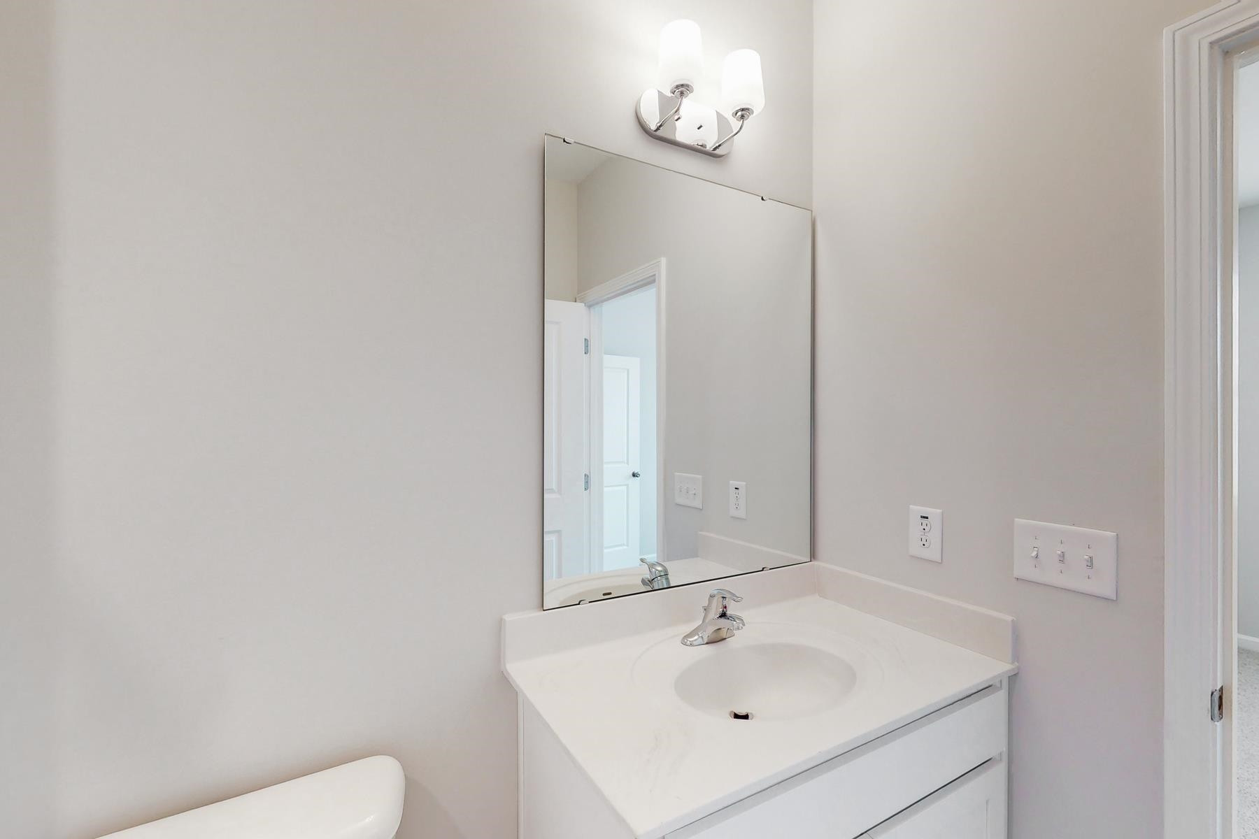 1007 Harmony Trail, Unit 16 Durham, NC 27703 - Photo 23 of 37 a bathroom with a sink a toilet and mirror