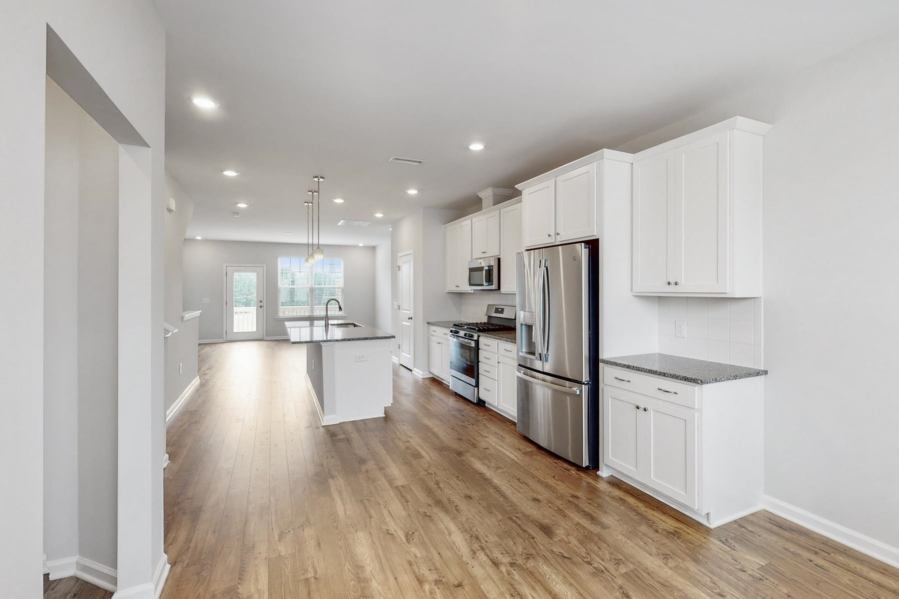1007 Harmony Trail, Unit 16 Durham, NC 27703 - Photo 6 of 37 a kitchen with white cabinets and stainless steel appliances