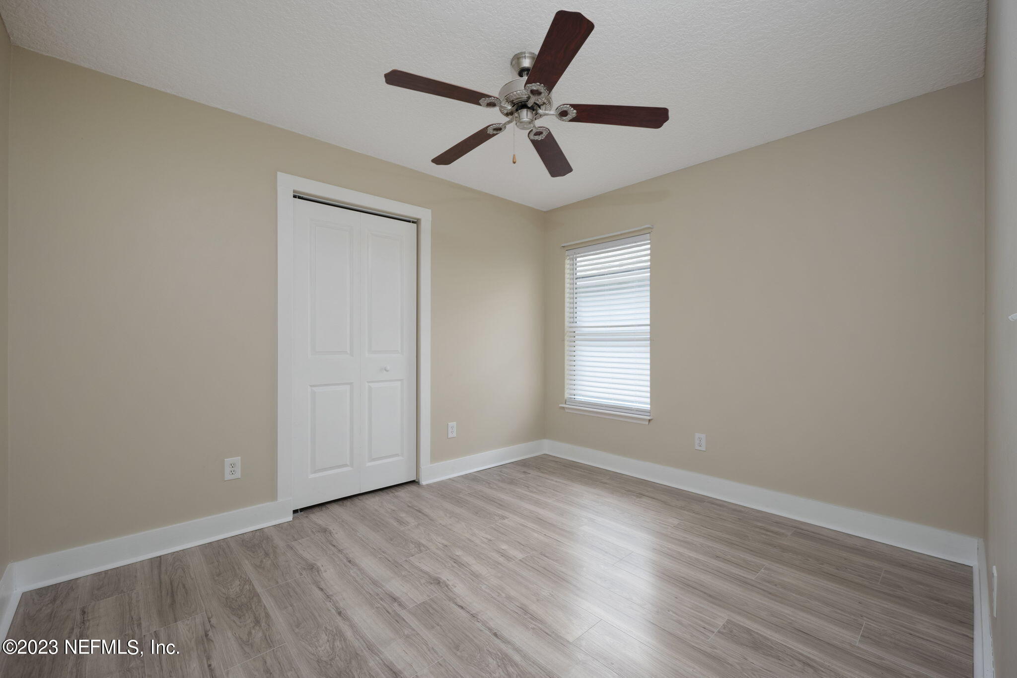 1040 Three Forks Court St. Augustine, FL 32092 - Photo 13 of 58 an empty room with wooden floor ceiling fan and windows