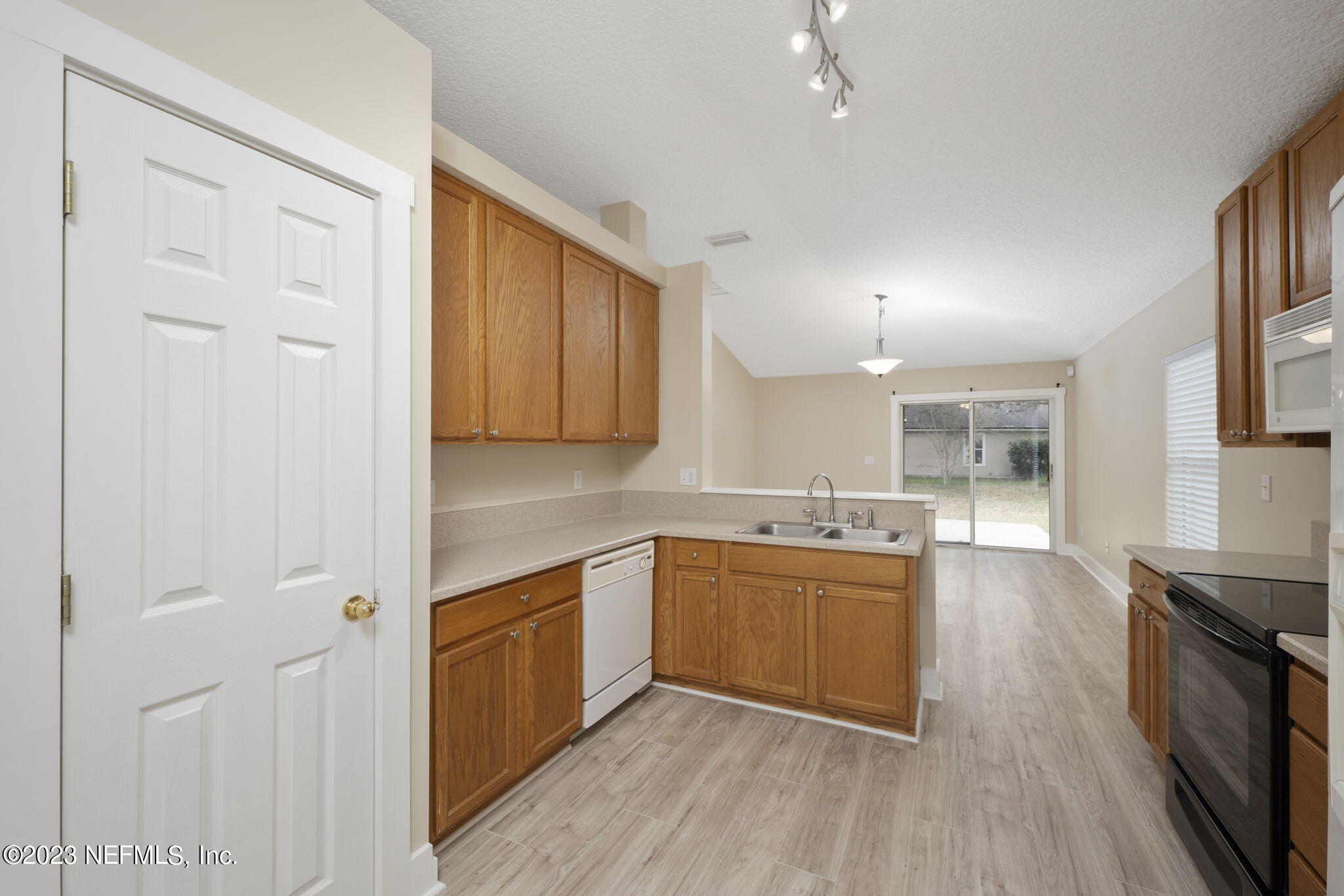 1040 Three Forks Court St. Augustine, FL 32092 - Photo 20 of 58 a kitchen with cabinets wooden floor and stainless steel appliances