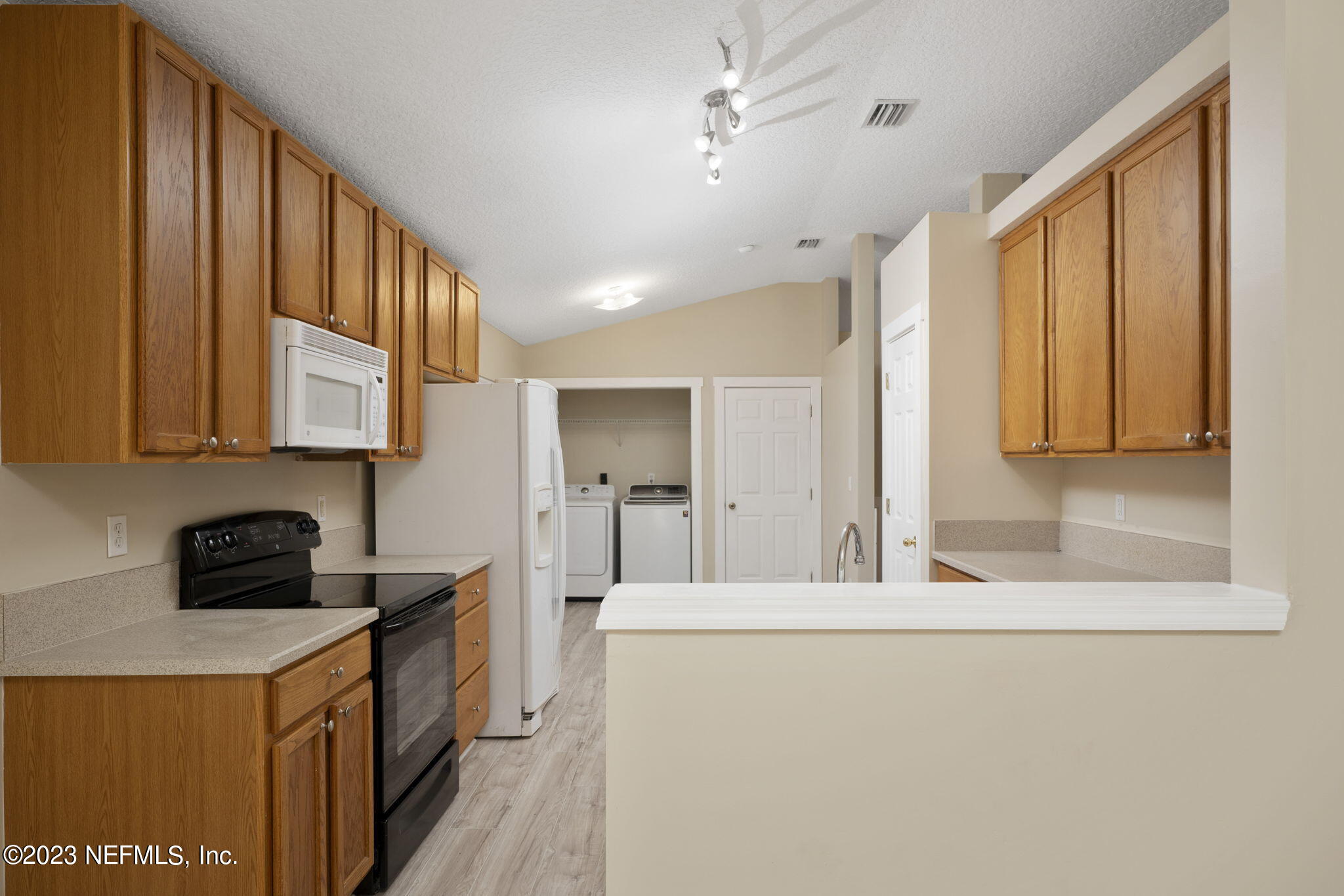 1040 Three Forks Court St. Augustine, FL 32092 - Photo 22 of 58 a kitchen with stainless steel appliances a stove a sink and a refrigerator