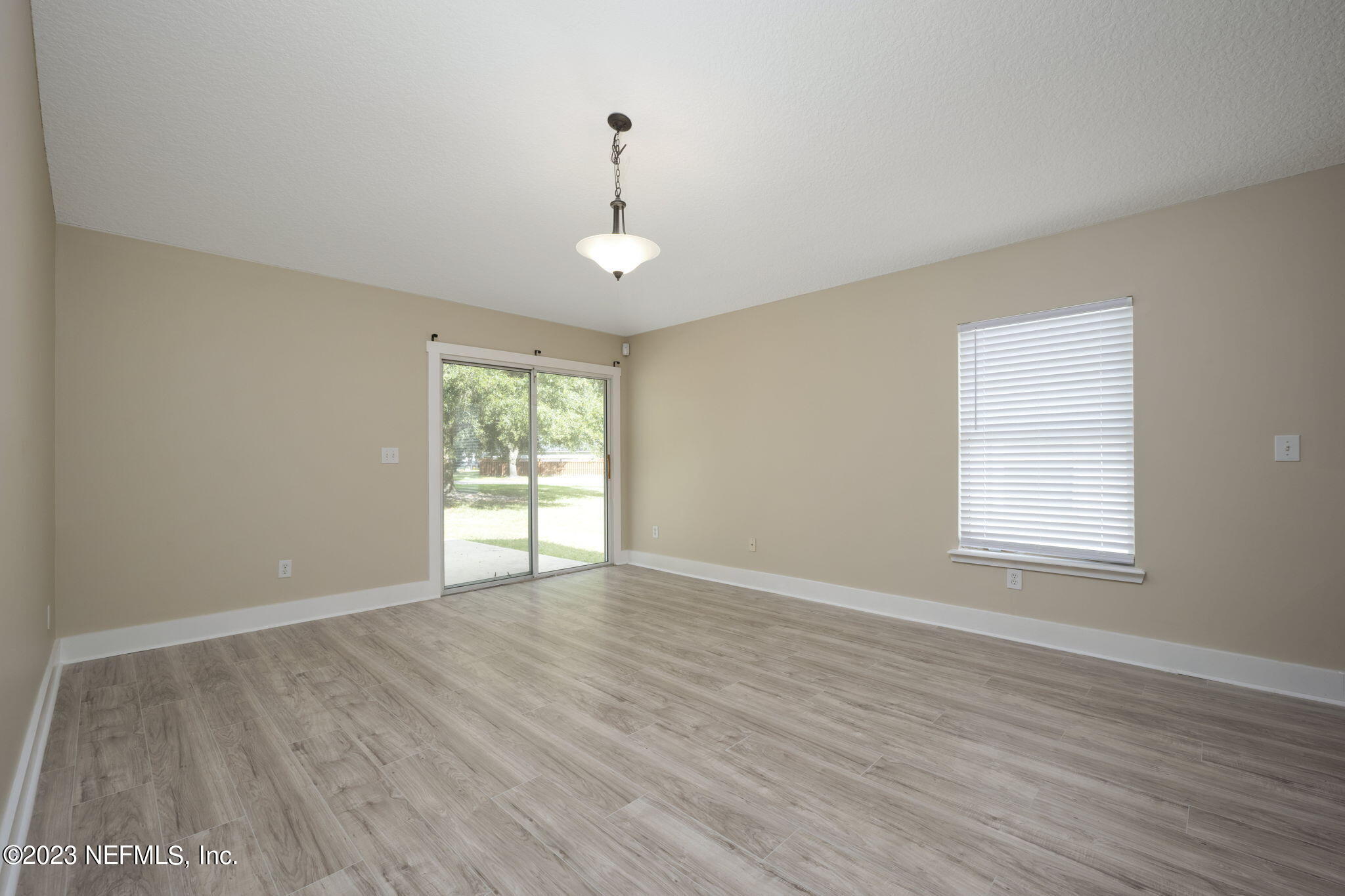 1040 Three Forks Court St. Augustine, FL 32092 - Photo 23 of 58 a view of an empty room with wooden floor and a window
