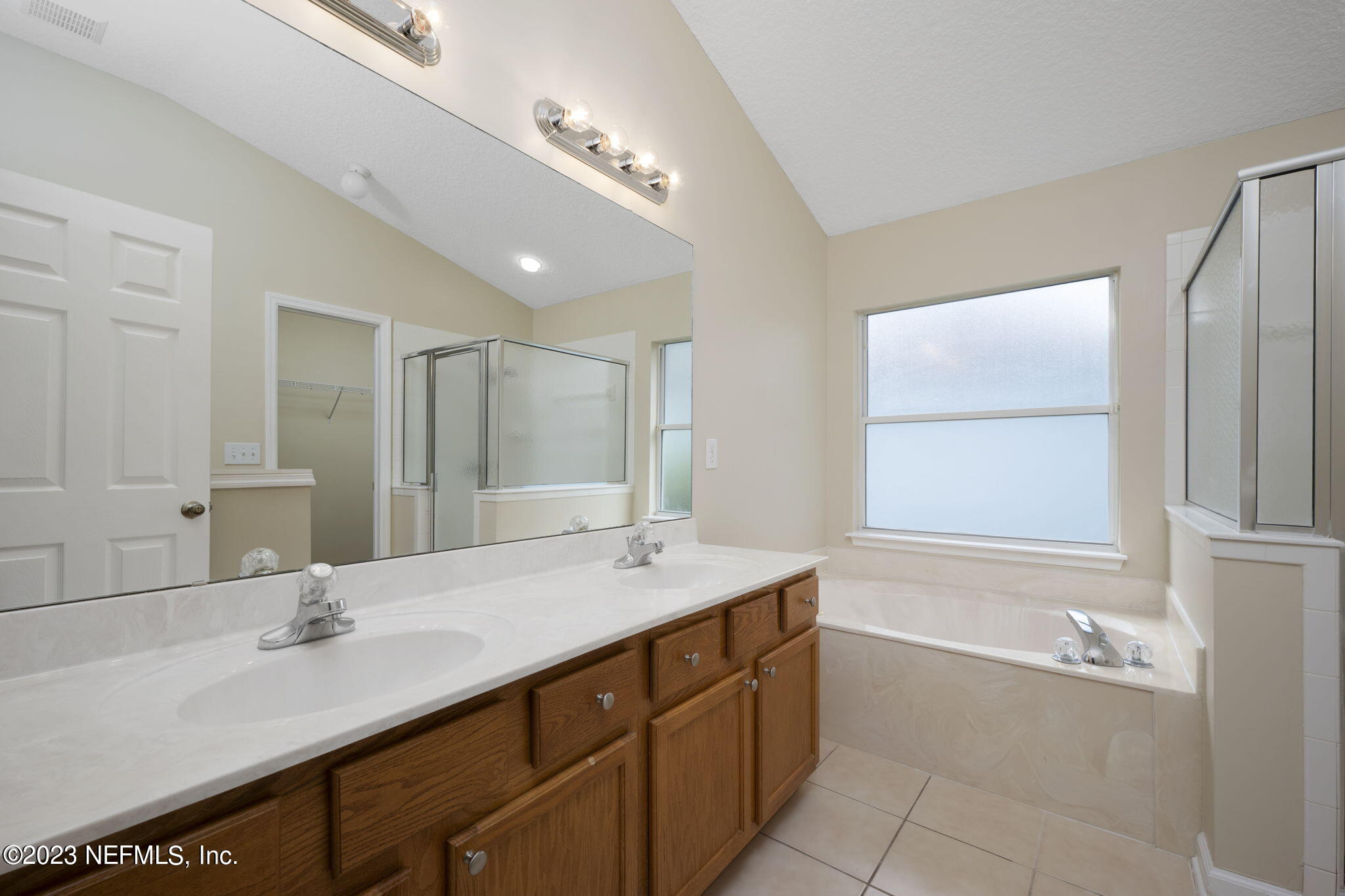 1040 Three Forks Court St. Augustine, FL 32092 - Photo 28 of 58 a bathroom with a tub sink and mirror