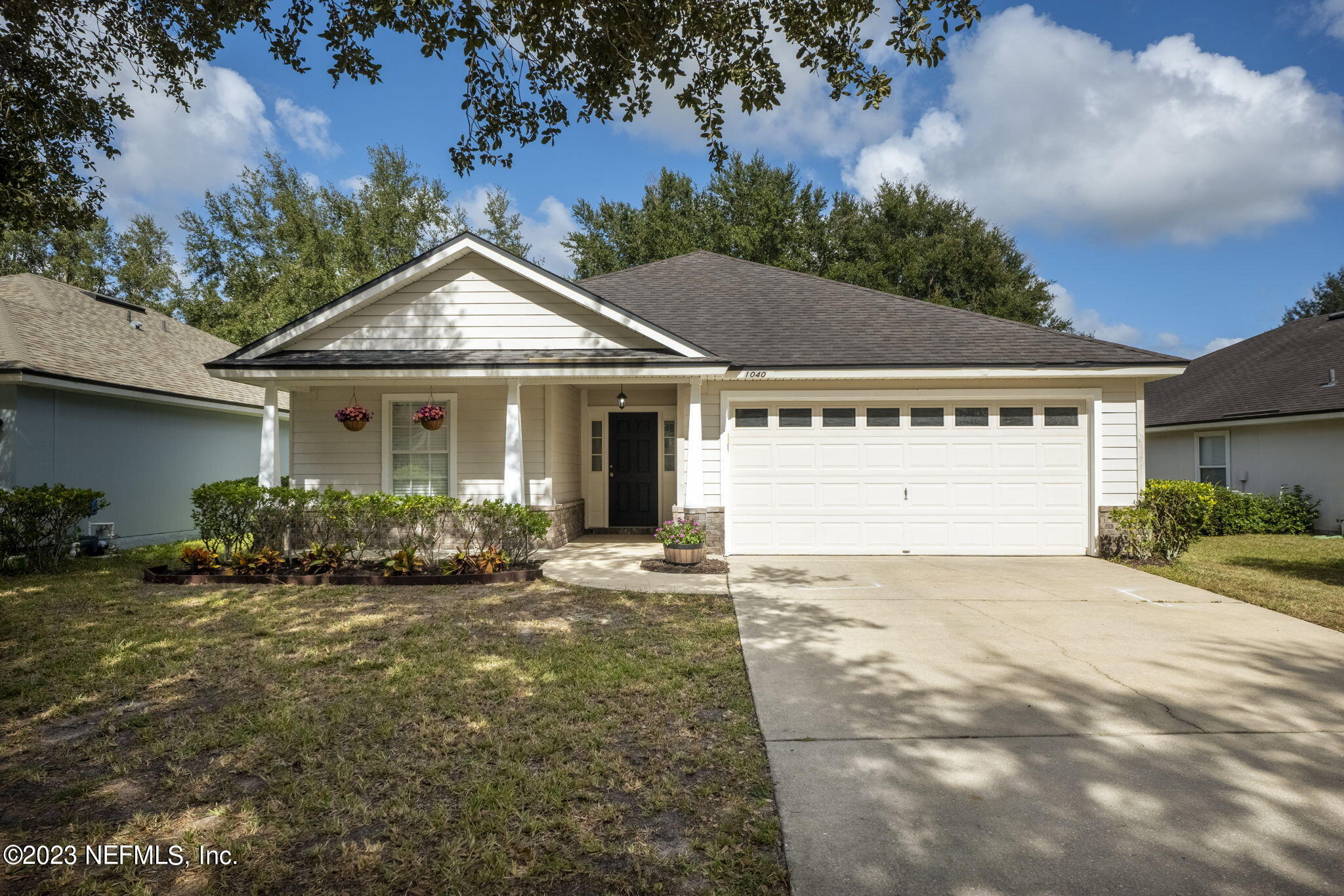 1040 Three Forks Court St. Augustine, FL 32092 - Photo 3 of 58 a front view of a house with a garden and yard
