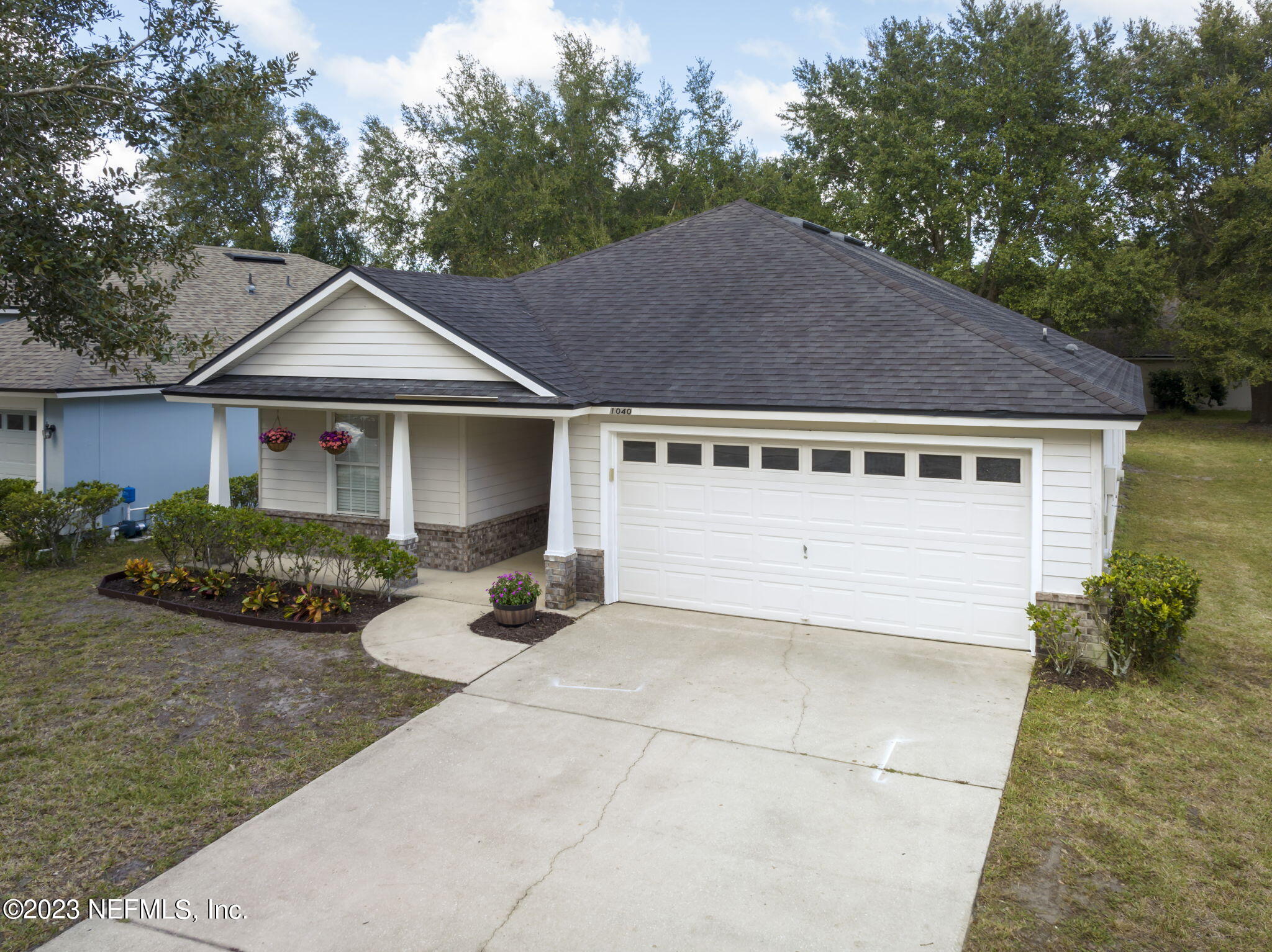 1040 Three Forks Court St. Augustine, FL 32092 - Photo 35 of 58 a front view of a house with garden