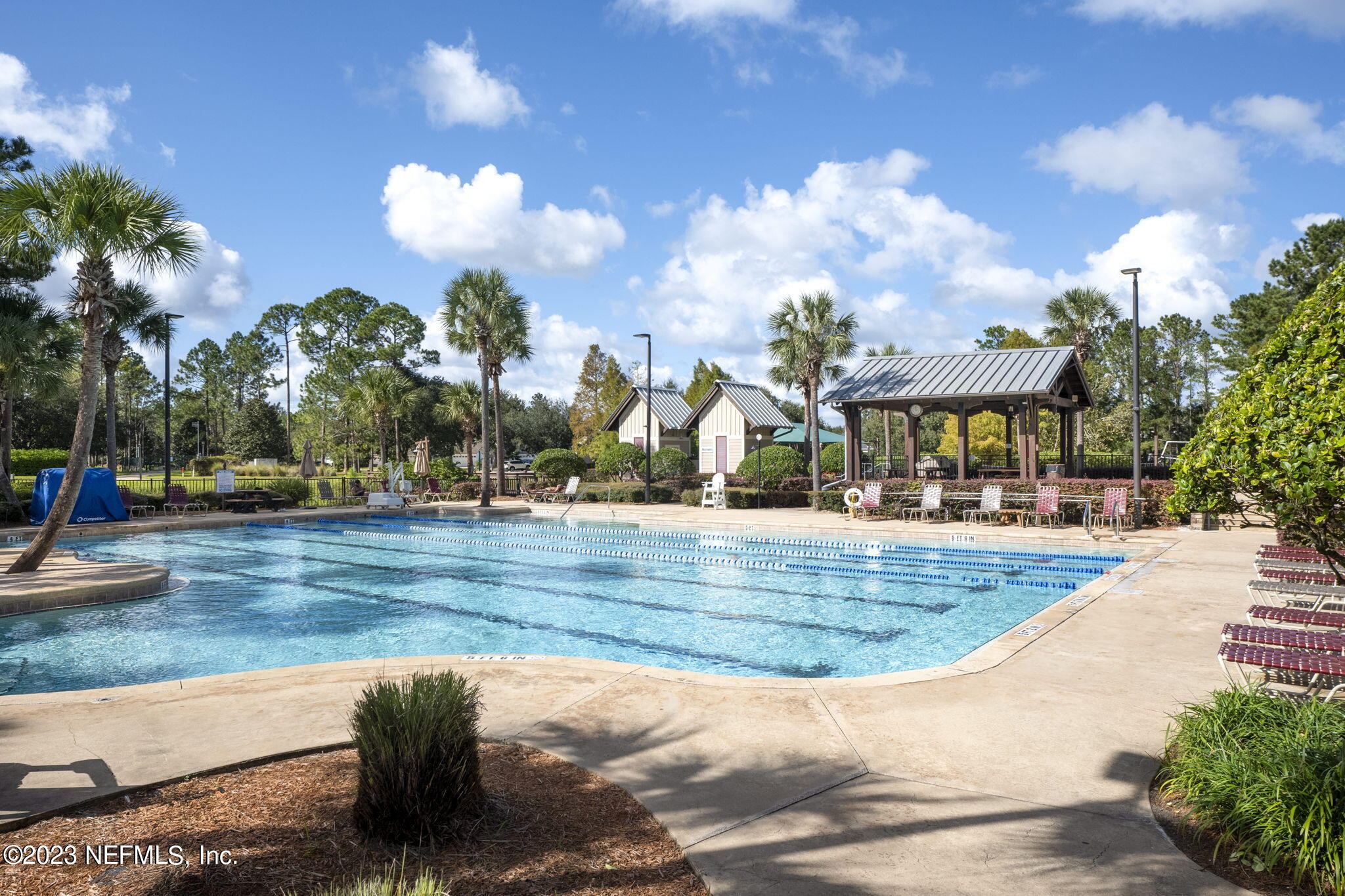 1040 Three Forks Court St. Augustine, FL 32092 - Photo 47 of 58 a view of a swimming pool with a bench in front of it