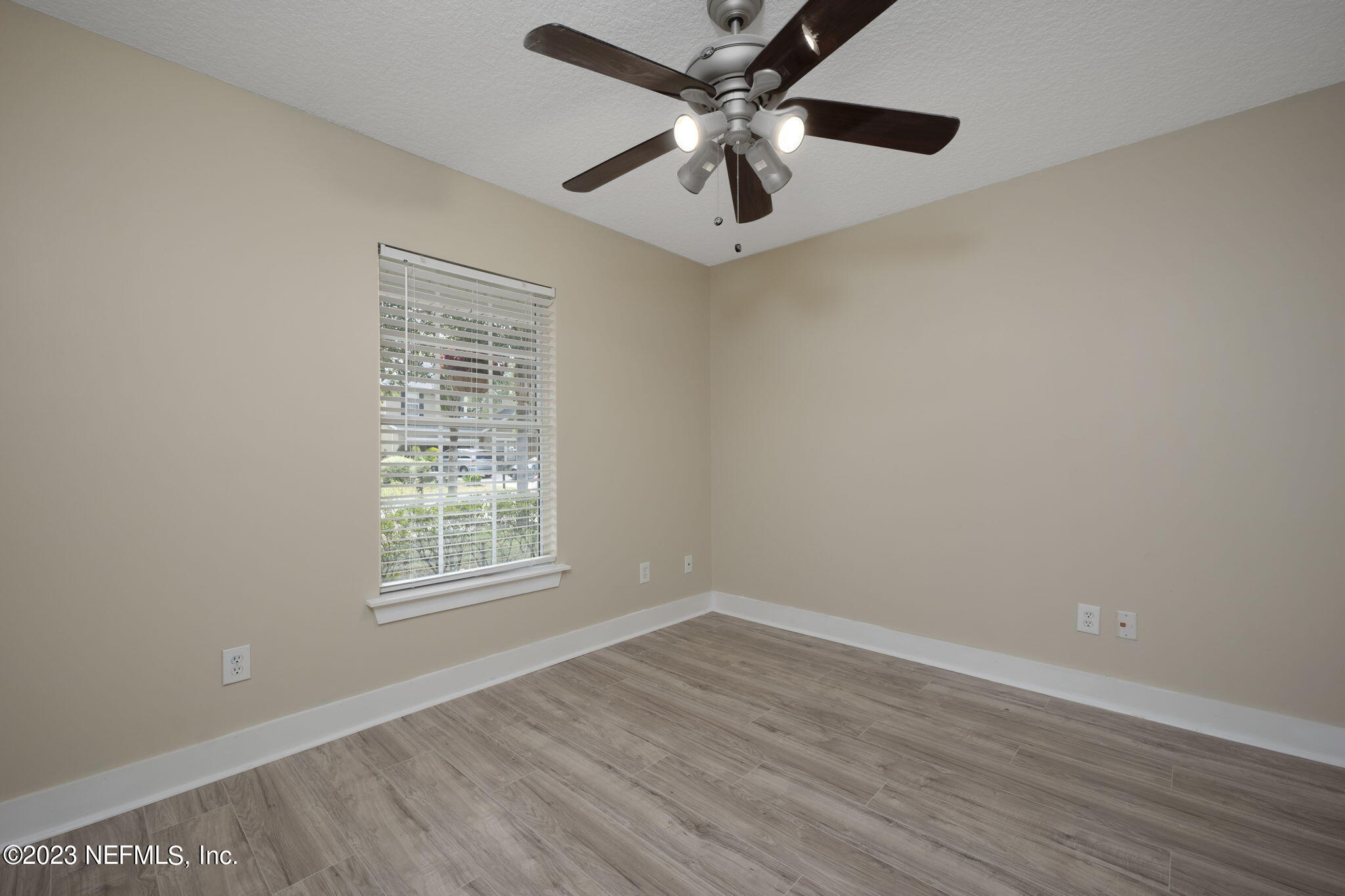 1040 Three Forks Court St. Augustine, FL 32092 - Photo 8 of 58 an empty room with wooden floor fan and windows
