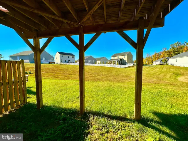 a view of balcony with wooden floor and fence