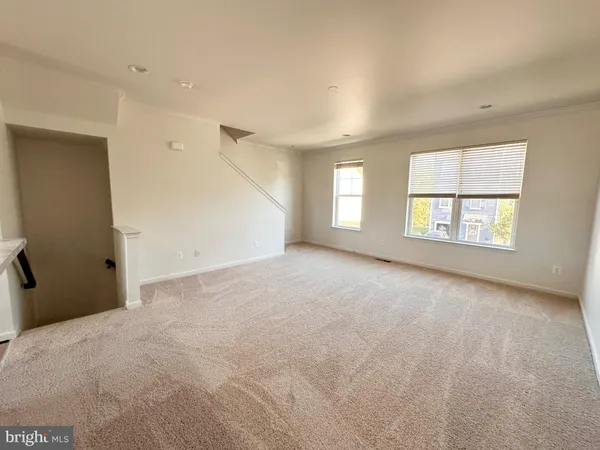 an empty room with windows and closet