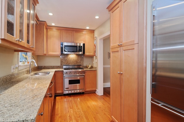2138 Illinois Road Northbrook, IL 60062 - Photo 7 of 15 a kitchen with granite countertop stainless steel appliances and counter space