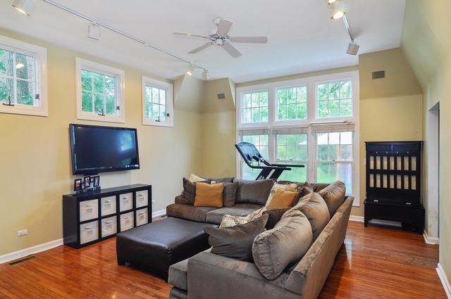 2138 Illinois Road Northbrook, IL 60062 - Photo 9 of 15 a living room with furniture a ceiling fan and a flat screen tv