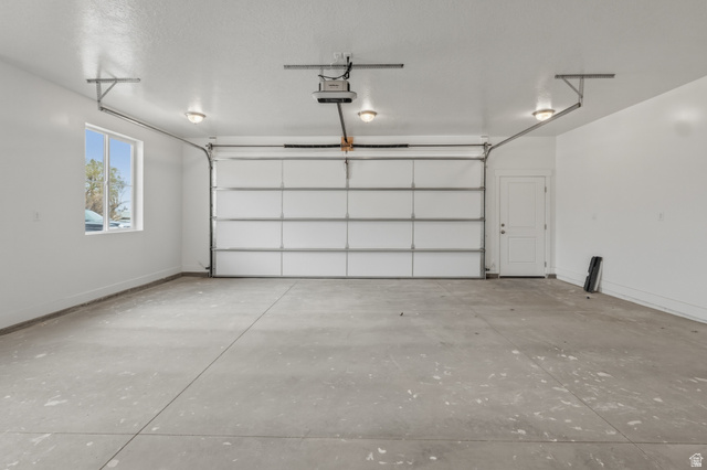 169 West 100 South Joseph, UT 84739 - Photo 34 of 35 Garage featuring baseboards and a garage door opener