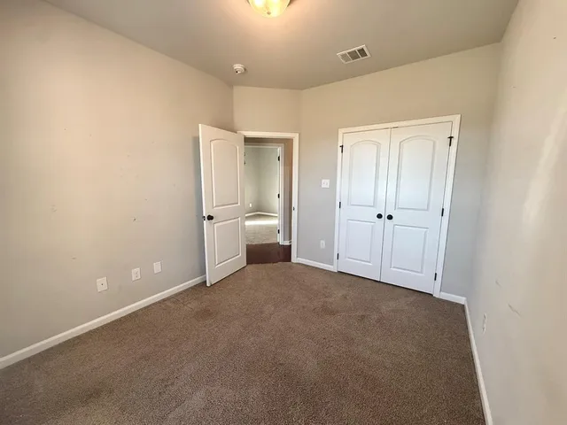 a view of a room with a empty space and bathroom space