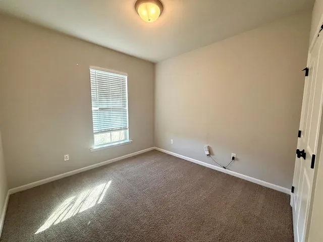 an empty room with a empty space and a window