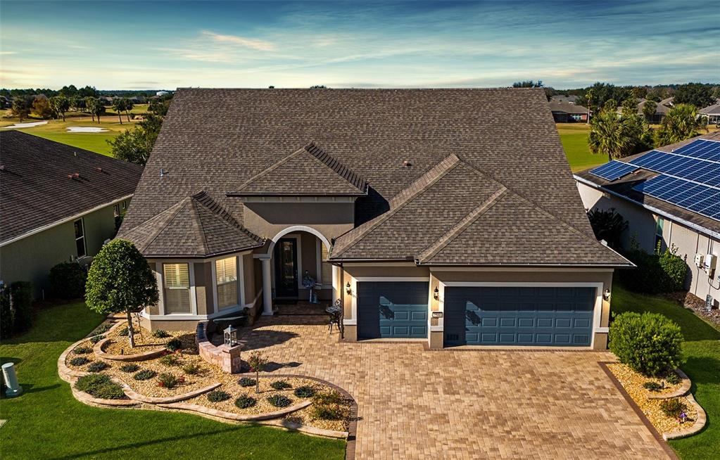 9551 Southwest 70th Loop Ocala, FL 34481 - Photo 1 of 1 a front view of a house with garden
