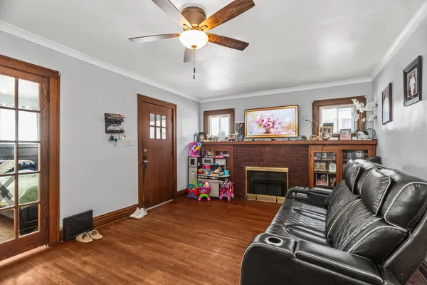 a living room with furniture fireplace and window