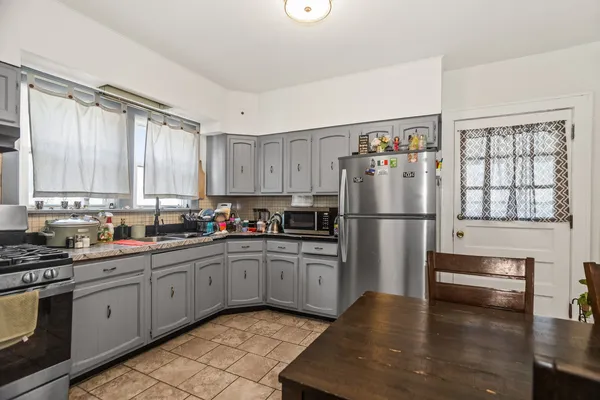 a kitchen with stainless steel appliances granite countertop a refrigerator sink and cabinets