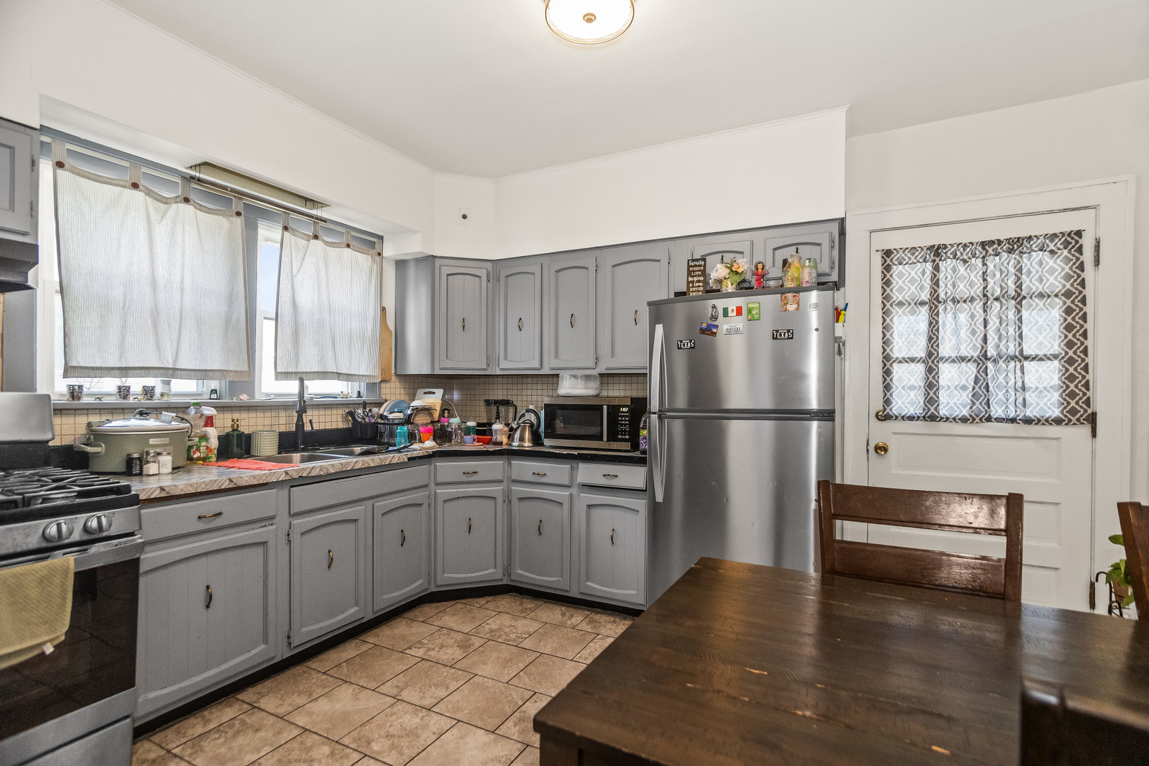 2514 Walnut Street Blue Island, IL 60406 - Photo 6 of 15 a kitchen with stainless steel appliances granite countertop a refrigerator sink and cabinets