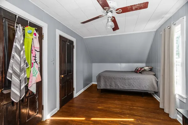 a bedroom with a bed and a book shelf