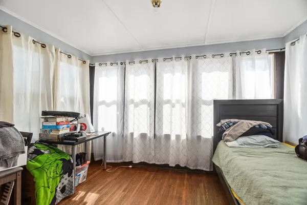 a bedroom with bed and a window