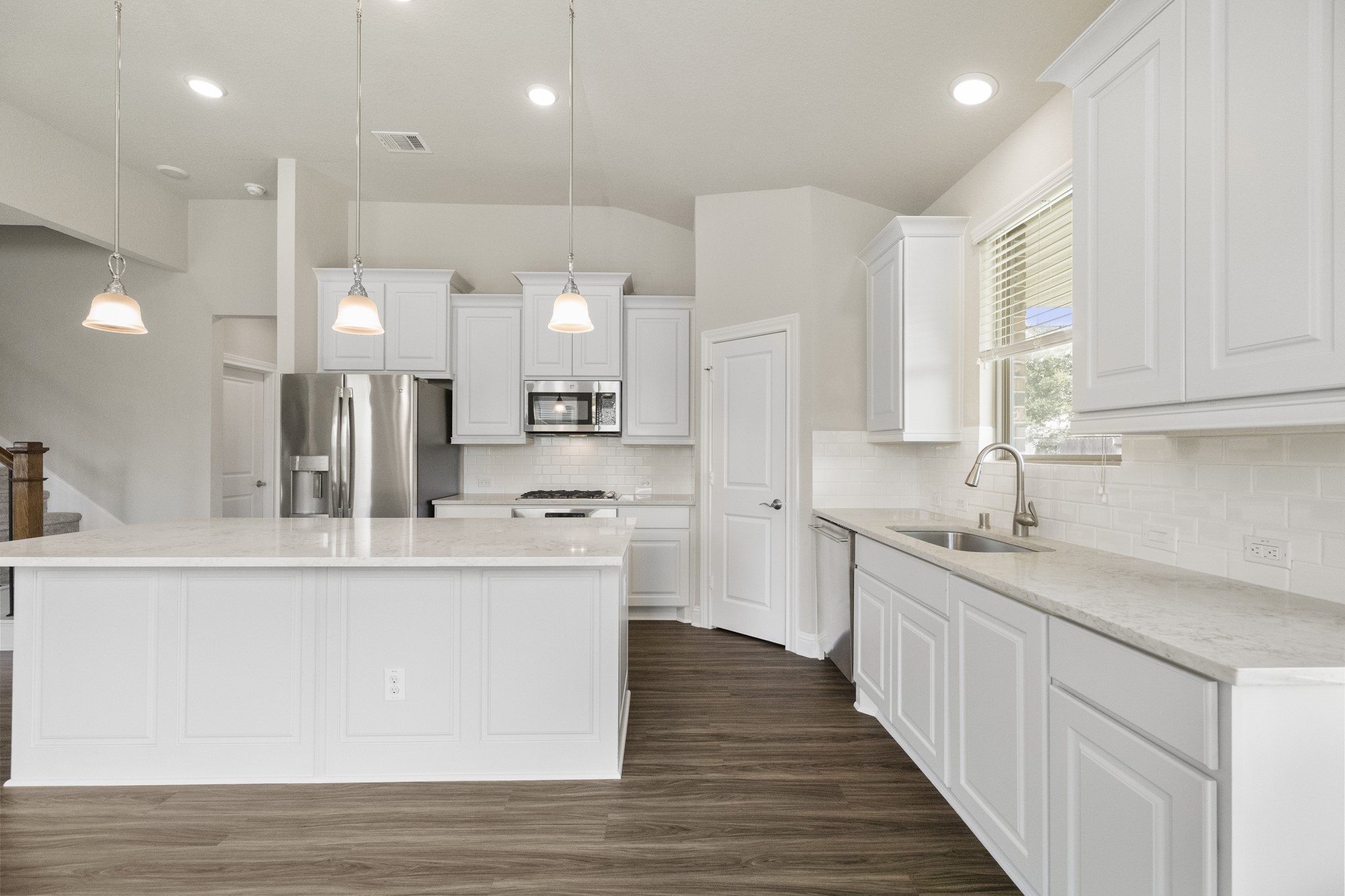 7502 Windsor Park Court Spring, TX 77379 - Photo 13 of 50 a large kitchen with stainless steel appliances a large counter top a stove a sink and a refrigerator