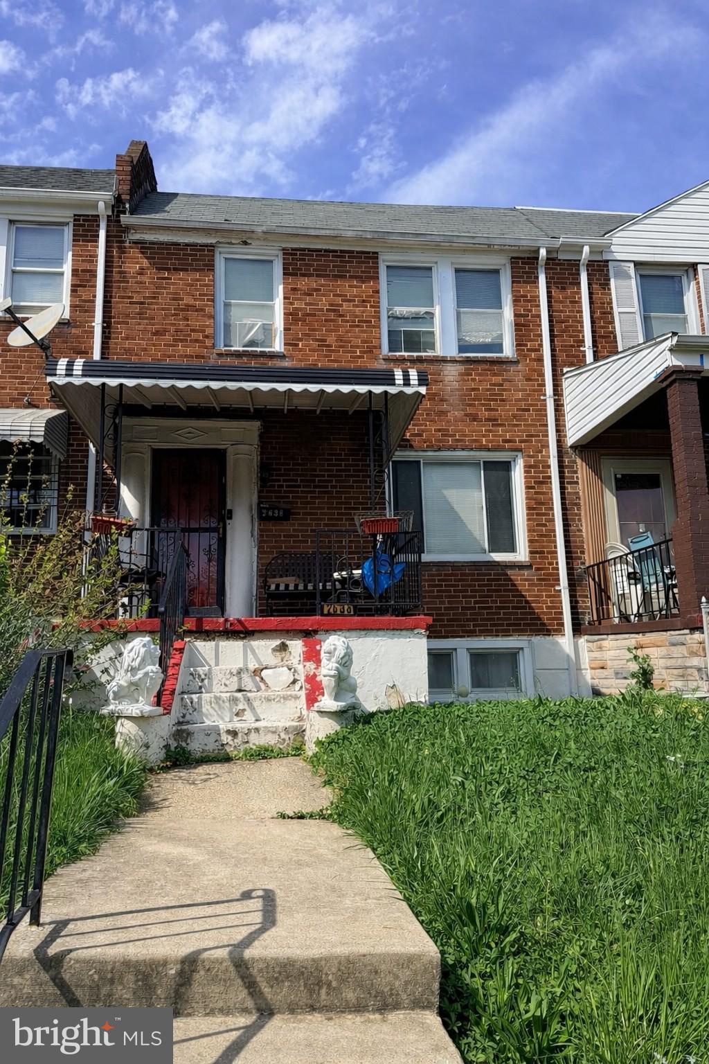 2638 Federal Street Baltimore, MD 21213 - Photo 1 of 24 a front view of a house with a yard and a garage
