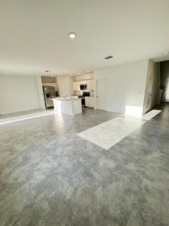 724 Reggie Road Winter Haven, FL 33859 - Photo 11 of 26 a view of a livingroom with kitchen and furniture