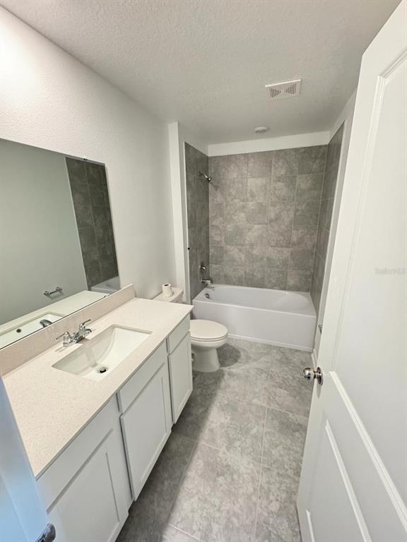 724 Reggie Road Winter Haven, FL 33859 - Photo 8 of 26 a bathroom with a sink a toilet and shower