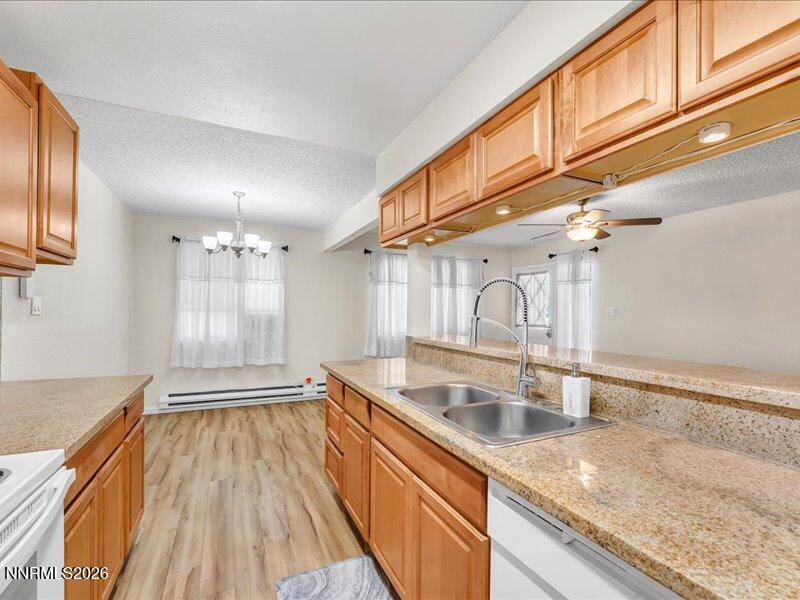 820 Jamaica Avenue, Unit 3 Reno, NV 89502 - Photo 11 of 19 a kitchen with granite countertop a sink a stove and cabinets