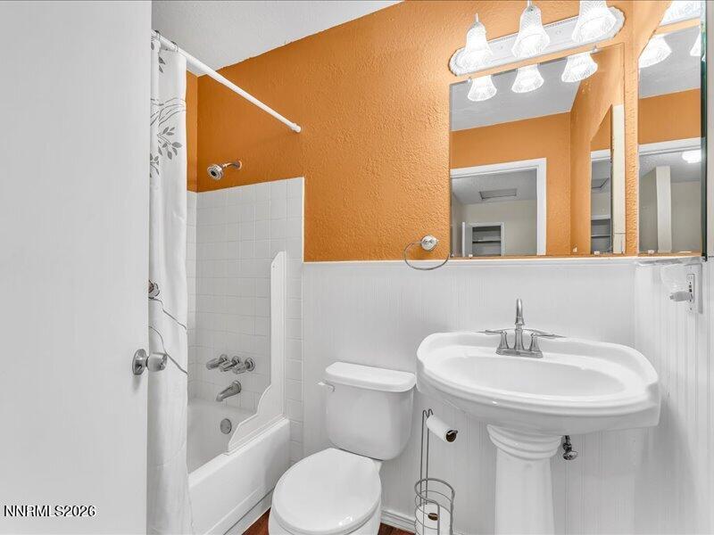 820 Jamaica Avenue, Unit 3 Reno, NV 89502 - Photo 17 of 19 a bathroom with a sink toilet and shower