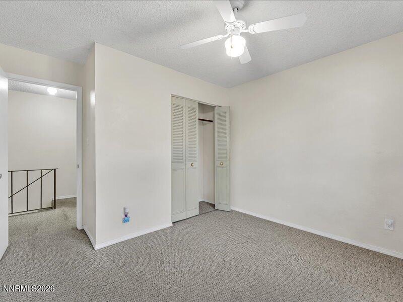 820 Jamaica Avenue, Unit 3 Reno, NV 89502 - Photo 19 of 19 an empty room with a ceiling fan and a fan