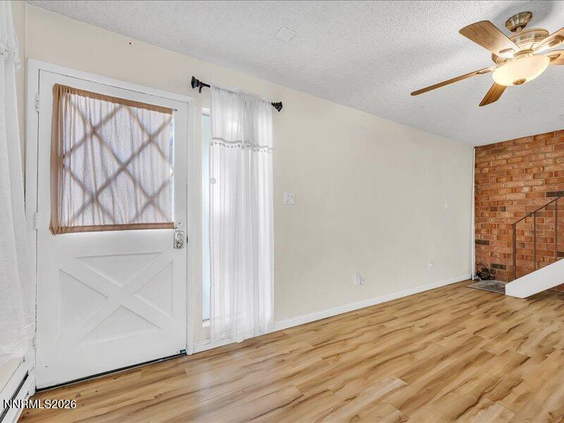 820 Jamaica Avenue, Unit 3 Reno, NV 89502 - Photo 2 of 19 a view of empty room with wooden floor and fan