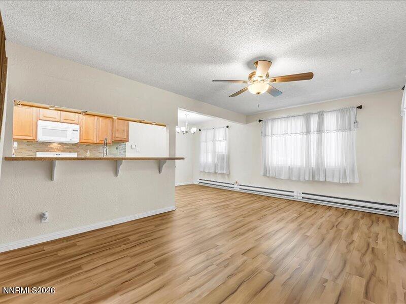 820 Jamaica Avenue, Unit 3 Reno, NV 89502 - Photo 3 of 19 wooden floor in an empty room with a window