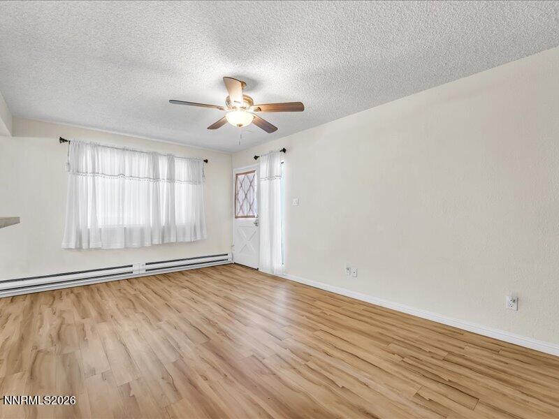 820 Jamaica Avenue, Unit 3 Reno, NV 89502 - Photo 4 of 19 an empty room with wooden floor and windows