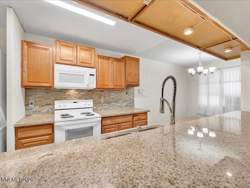 820 Jamaica Avenue, Unit 3 Reno, NV 89502 - Photo 5 of 19 a kitchen with stainless steel appliances granite countertop a stove a sink and a microwave