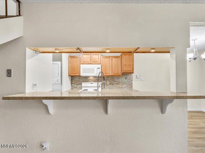 820 Jamaica Avenue, Unit 3 Reno, NV 89502 - Photo 6 of 19 a kitchen with granite countertop a sink and a white cabinets