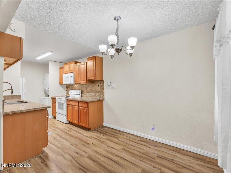 820 Jamaica Avenue, Unit 3 Reno, NV 89502 - Photo 7 of 19 a view of a kitchen with a sink dishwasher a refrigerator and wooden floor