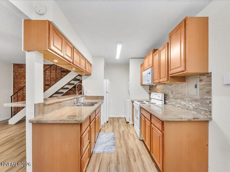 820 Jamaica Avenue, Unit 3 Reno, NV 89502 - Photo 9 of 19 a kitchen with stainless steel appliances granite countertop a sink a stove and a wooden floors