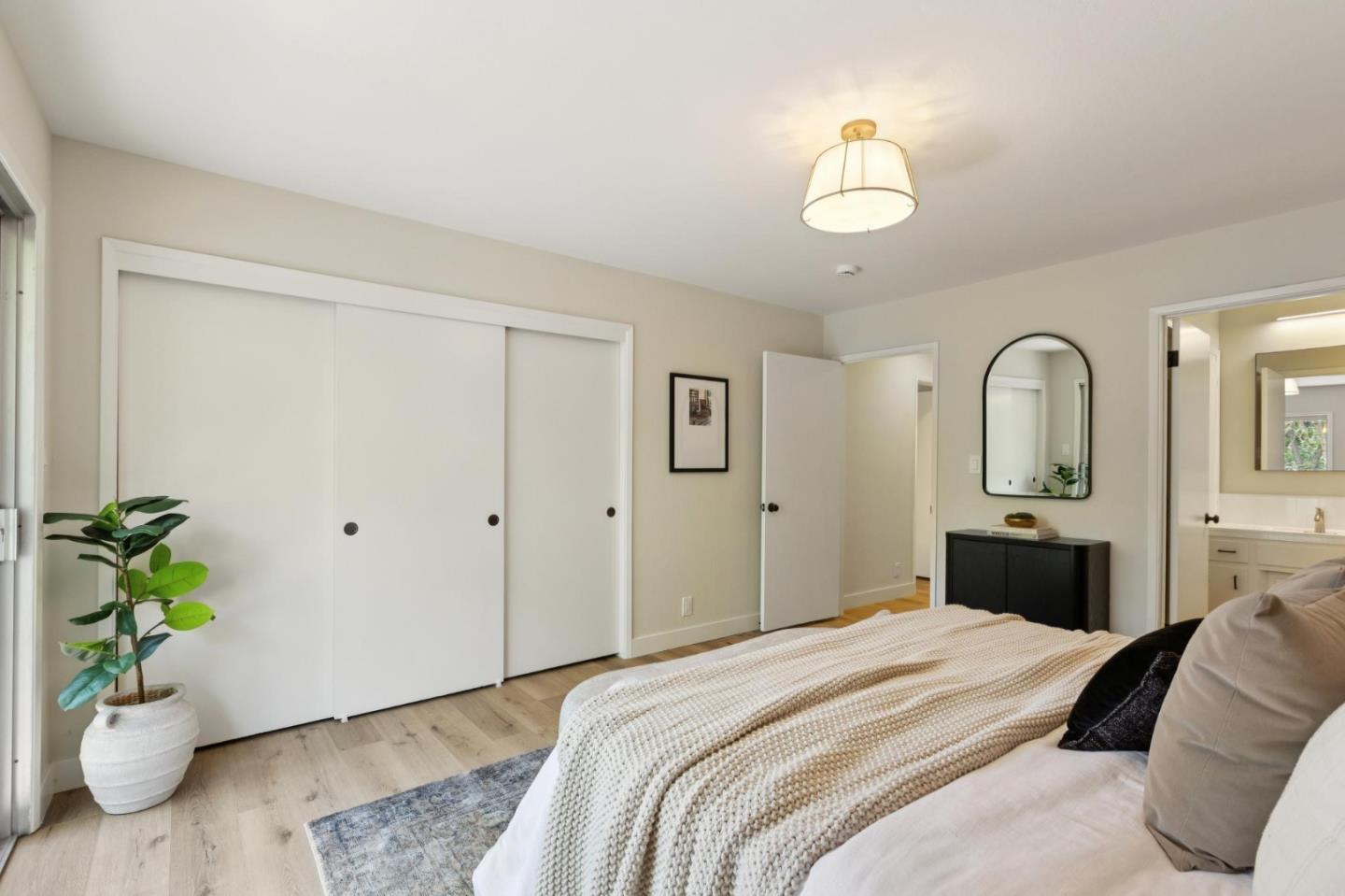 755 Santa Rita Avenue Los Altos, CA 94022 - Photo 29 of 50 a bedroom with a bed and a chandelier