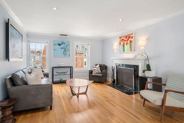a living room with furniture a fireplace and a window