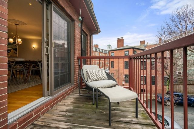 a view of a balcony with chairs