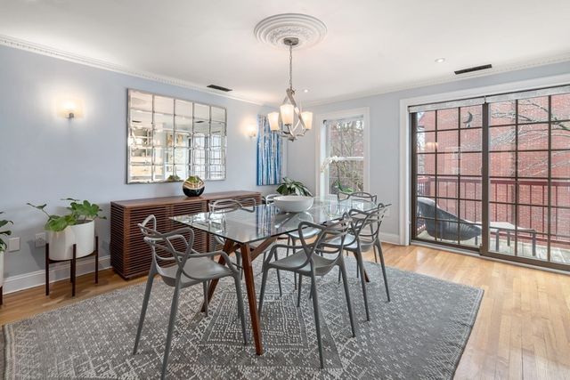 a view of a dining room with furniture and window