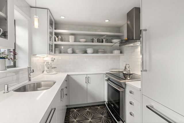 a kitchen that has a sink and a stove