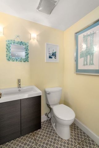 a bathroom with a toilet a sink and mirror