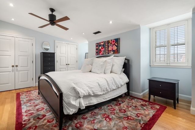 a bedroom with bed and a chandelier