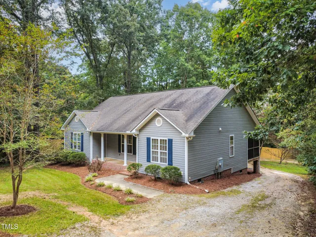 a backyard of a house with yard and outdoor seating